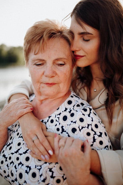 Adult daughter embracing her elderly mother